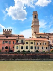 Beautiful architectural view of Verona Cathedral and surrounding buildings along the Adige River in Italy.